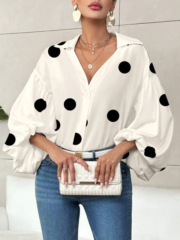 Polka dot, loose-fitting, puff-sleeved top with a semi-open collar.